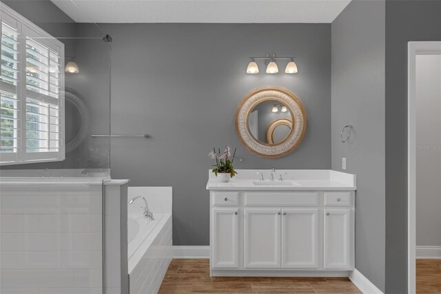 32004 Redtail Reserve Blvd, Sorrento, FL 32776 - bathroom featuring vanity, a bath, plenty of natural light, and wood finished floors