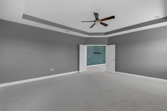32004 Redtail Reserve Blvd, Sorrento, FL 32776 - spare room with ceiling fan, concrete flooring, and a tray ceiling