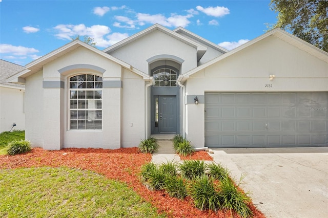 2767 Aragon Ter, Lake Mary, FL 32746 - view of front of property featuring a garage, stucco siding, and concrete driveway