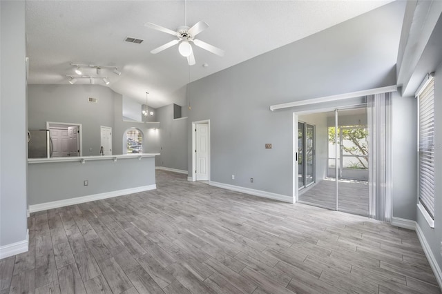 2767 Aragon Ter, Lake Mary, FL 32746 - unfurnished living room featuring a ceiling fan, wood finished floors, high vaulted ceiling, a chandelier, and track lighting
