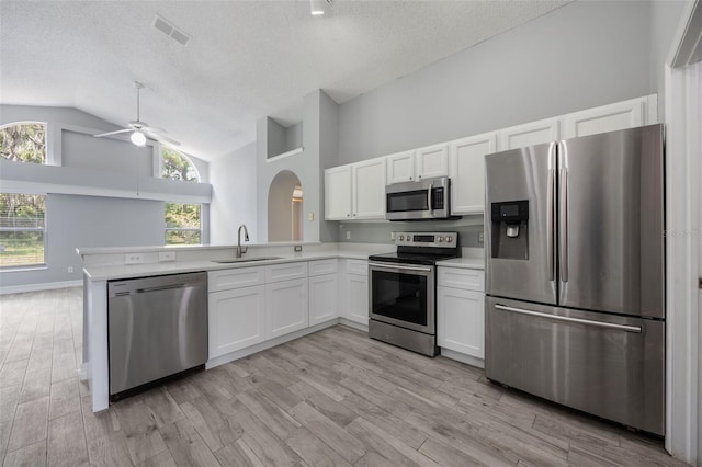 2767 Aragon Ter, Lake Mary, FL 32746 - kitchen with appliances with stainless steel finishes, a ceiling fan, a textured ceiling, light countertops, and arched walkways