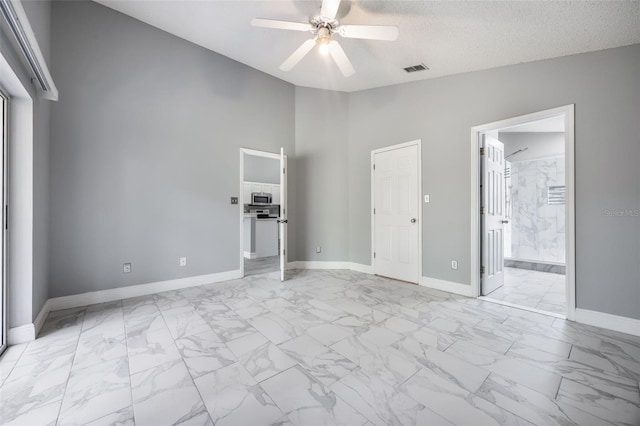 2767 Aragon Ter, Lake Mary, FL 32746 - unfurnished bedroom featuring light marble finish floors, high vaulted ceiling, ensuite bath, and ceiling fan