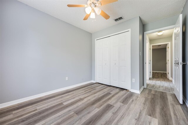 2767 Aragon Ter, Lake Mary, FL 32746 - unfurnished bedroom with wood finished floors, a closet, ceiling fan, and a textured ceiling