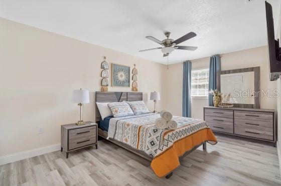 4311 123rd St W, Cortez, FL 34215 - bedroom with light wood finished floors and a ceiling fan