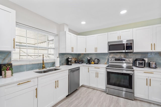 4311 123rd St W, Cortez, FL 34215 - kitchen with appliances with stainless steel finishes, light countertops, white cabinets, backsplash, and recessed lighting