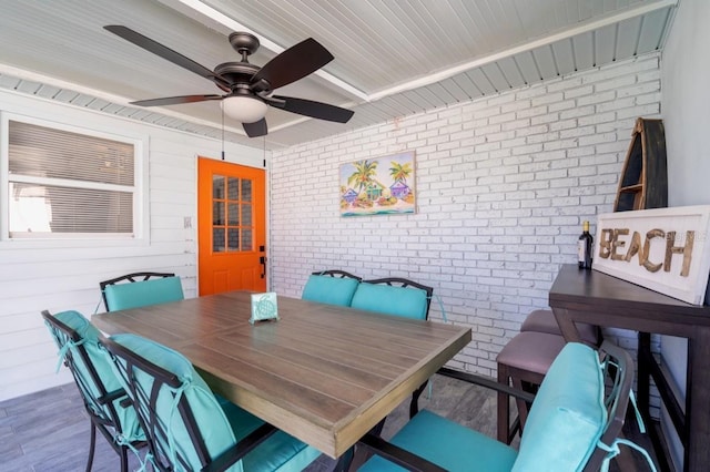 4311 123rd St W, Cortez, FL 34215 - dining room with brick wall, wood finished floors, and a ceiling fan