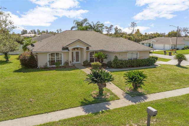 710 Independence Dr, Orange City, FL 32763 - view of front facade with stucco siding, a front lawn, and french doors