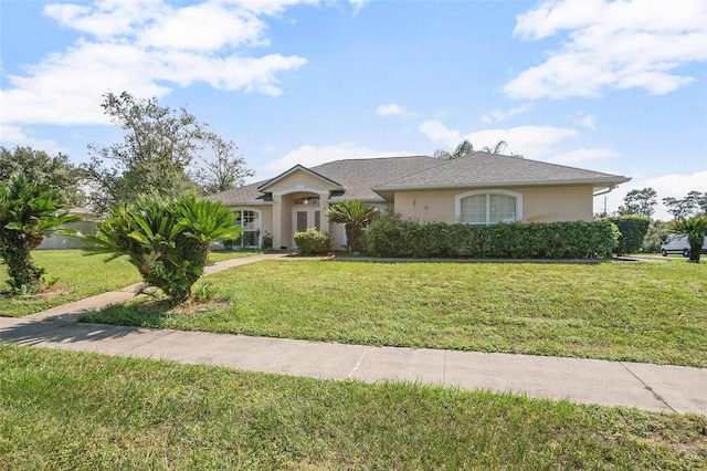 710 Independence Dr, Orange City, FL 32763 - ranch-style home featuring a front lawn and stucco siding