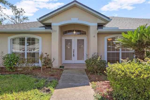 710 Independence Dr, Orange City, FL 32763 - entrance to property featuring french doors, a shingled roof, and stucco siding