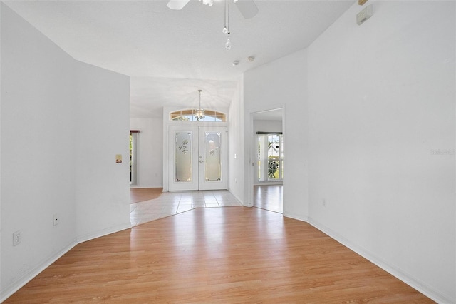 710 Independence Dr, Orange City, FL 32763 - entrance foyer with light wood-style floors, ceiling fan, a chandelier, and french doors