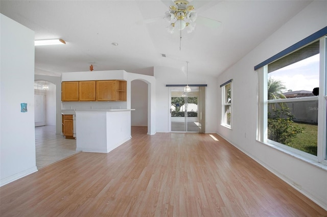 710 Independence Dr, Orange City, FL 32763 - unfurnished living room featuring arched walkways, light wood-style floors, ceiling fan, and lofted ceiling