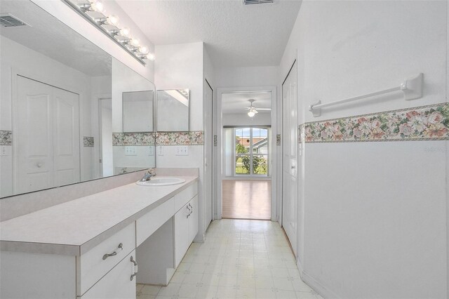 710 Independence Dr, Orange City, FL 32763 - bathroom with vanity, tile patterned floors, a ceiling fan, and a textured ceiling