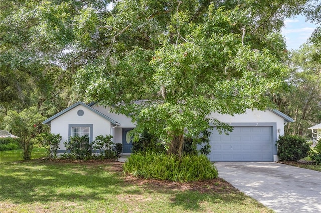 5990 SE 5th Pl, Ocala, FL 34472 - view of front of house featuring driveway, an attached garage, a front lawn, and stucco siding
