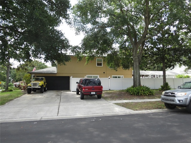 1420 Center St, Ocoee, FL 34761 - view of front facade featuring driveway, a garage, and stucco siding