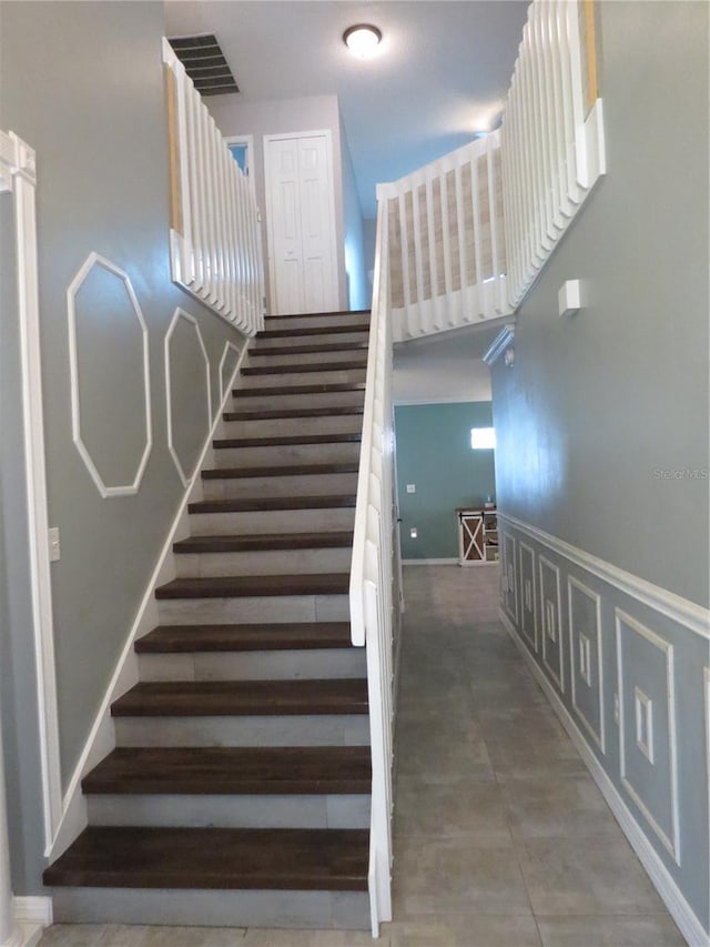 1420 Center St, Ocoee, FL 34761 - staircase featuring a wainscoted wall