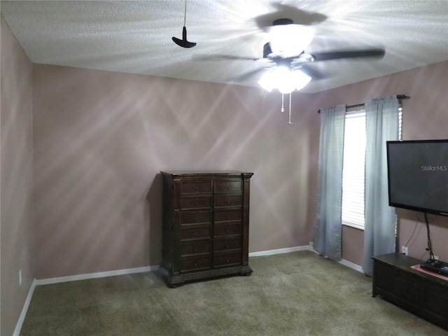 1420 Center St, Ocoee, FL 34761 - unfurnished bedroom featuring carpet flooring, a textured ceiling, and a ceiling fan