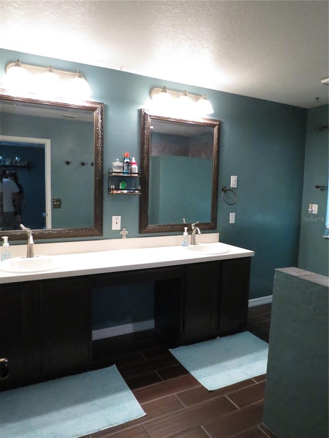 1420 Center St, Ocoee, FL 34761 - bathroom featuring double vanity, wood tiled floors, and a textured ceiling
