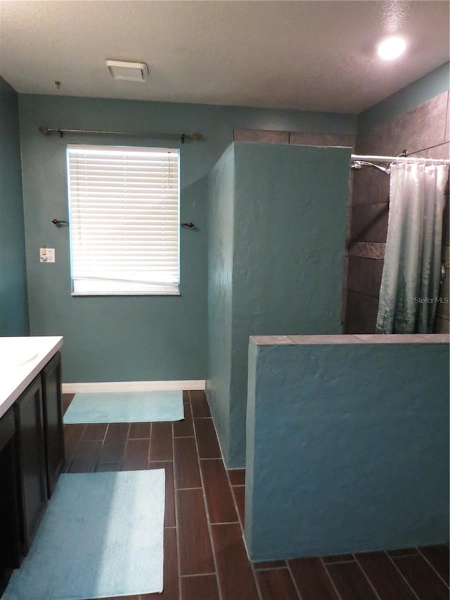 1420 Center St, Ocoee, FL 34761 - full bath with a tile shower, vanity, and wood finish floors
