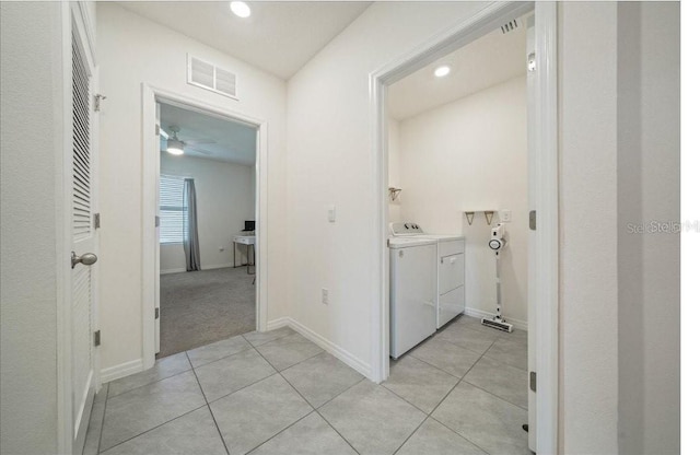 133 Hickory Course Cir, Ocala, FL 34472 - corridor featuring washing machine and clothes dryer, light tile patterned flooring, and recessed lighting