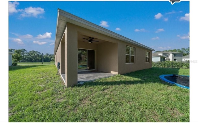133 Hickory Course Cir, Ocala, FL 34472 - rear view of property with ceiling fan, stucco siding, a patio area, and a yard
