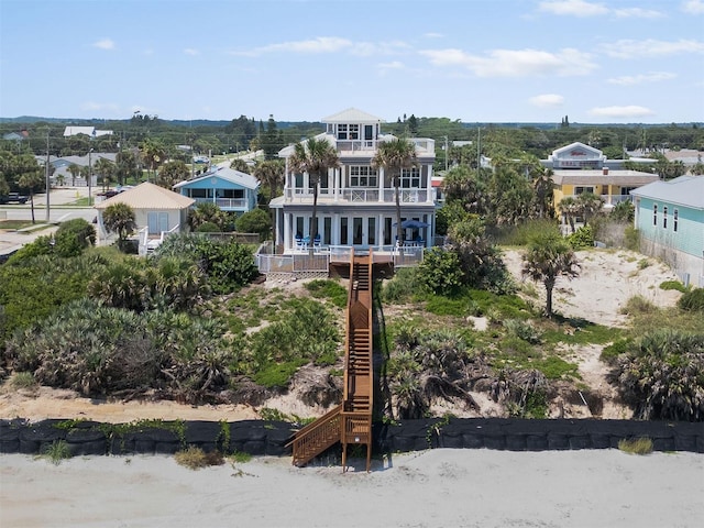 3309 Hill St, New Smyrna Beach, FL 32169 - rear view of house with a balcony and stairs