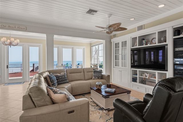 3309 Hill St, New Smyrna Beach, FL 32169 - living area with a chandelier, ceiling fan, light tile patterned floors, and decorative columns