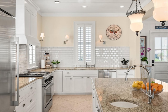 3309 Hill St, New Smyrna Beach, FL 32169 - kitchen featuring high end appliances, white cabinetry, light tile patterned floors, backsplash, and custom exhaust hood