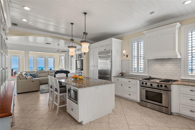 3309 Hill St, New Smyrna Beach, FL 32169 - kitchen featuring built in appliances, open floor plan, light tile patterned flooring, white cabinets, and recessed lighting