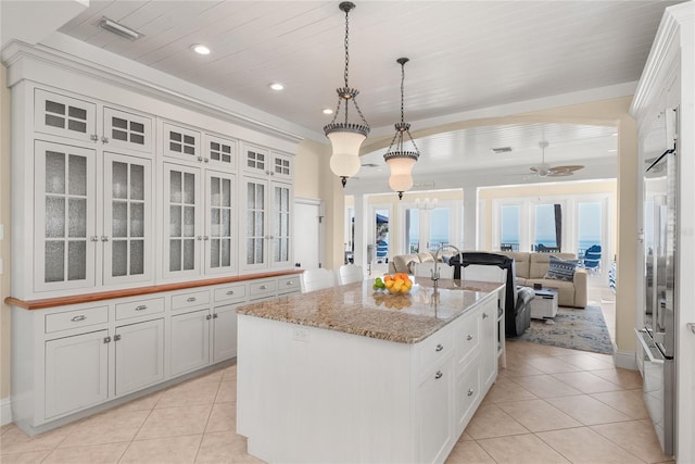 3309 Hill St, New Smyrna Beach, FL 32169 - kitchen featuring light tile patterned floors, ceiling fan, an island with sink, open floor plan, and recessed lighting