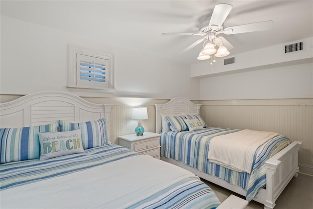 3309 Hill St, New Smyrna Beach, FL 32169 - bedroom featuring wainscoting and a ceiling fan