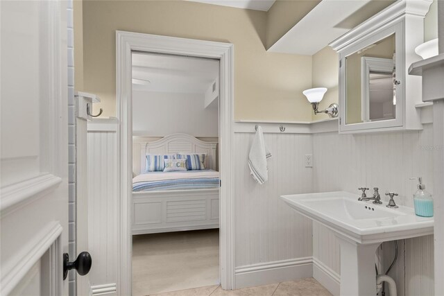 3309 Hill St, New Smyrna Beach, FL 32169 - ensuite bathroom featuring wainscoting and tile patterned flooring