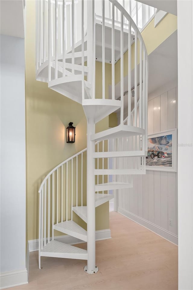3309 Hill St, New Smyrna Beach, FL 32169 - stairway featuring wood finished floors and a high ceiling