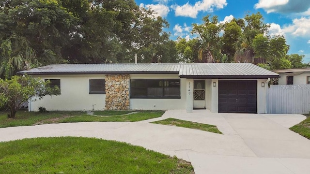 1148 Northcrest Dr, Apopka, FL 32703 - single story home with an attached garage, driveway, stucco siding, and a metal roof