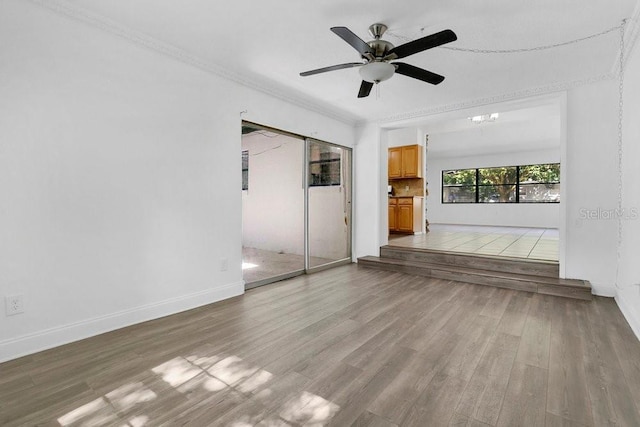 1148 Northcrest Dr, Apopka, FL 32703 - unfurnished living room featuring wood finished floors, ceiling fan, ornamental molding, and a chandelier