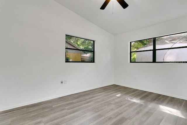 1148 Northcrest Dr, Apopka, FL 32703 - spare room with healthy amount of natural light, lofted ceiling, a ceiling fan, and wood finished floors