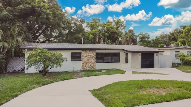 1148 Northcrest Dr, Apopka, FL 32703 - ranch-style house with driveway, a garage, stucco siding, and a metal roof