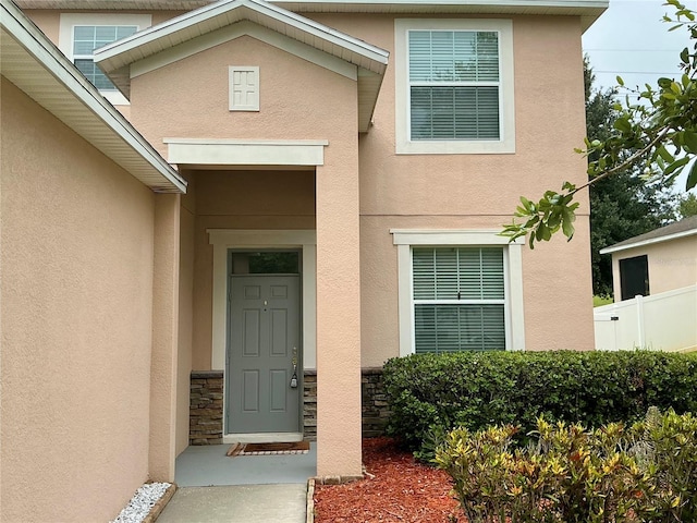5917 Coquyt Dr, Mount Dora, FL 32757 - property entrance with stucco siding and stone siding