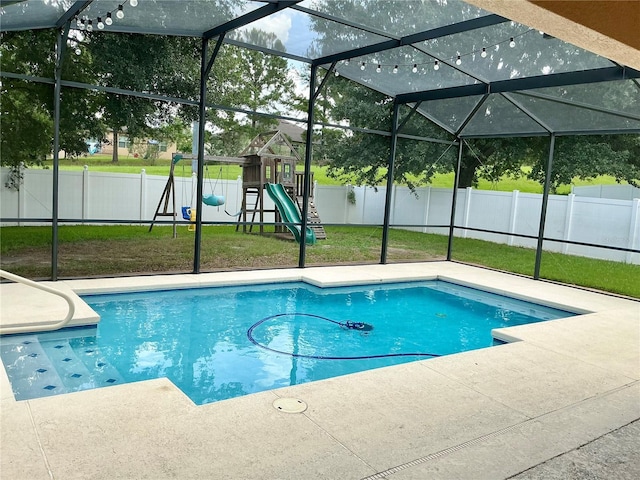 5917 Coquyt Dr, Mount Dora, FL 32757 - view of swimming pool featuring a fenced backyard, a playground, a patio area, and glass enclosure