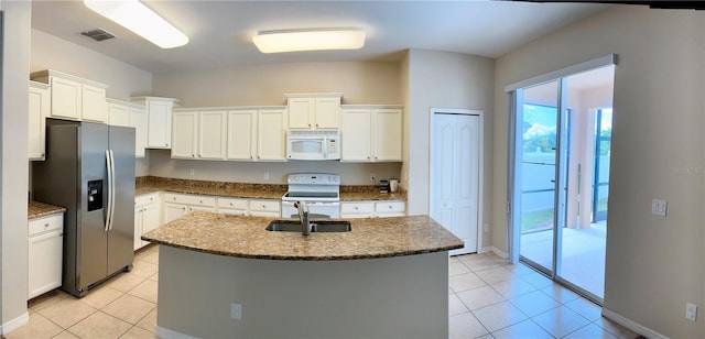 5917 Coquyt Dr, Mount Dora, FL 32757 - kitchen with white appliances, light tile patterned floors, and white cabinets