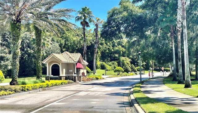 5917 Coquyt Dr, Mount Dora, FL 32757 - view of asphalt road featuring street lighting, curbs, and sidewalks