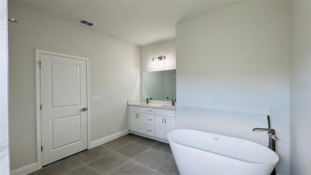 2500 SW 156th Ln Rd, Ocala, FL 34473 - full bath with double vanity, a freestanding bath, and tile patterned floors