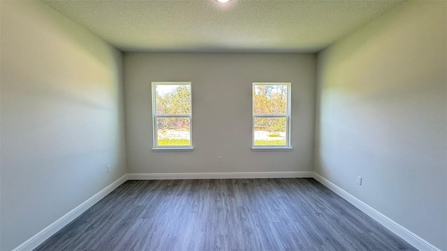 2500 SW 156th Ln Rd, Ocala, FL 34473 - unfurnished room featuring dark wood-style floors and a textured ceiling