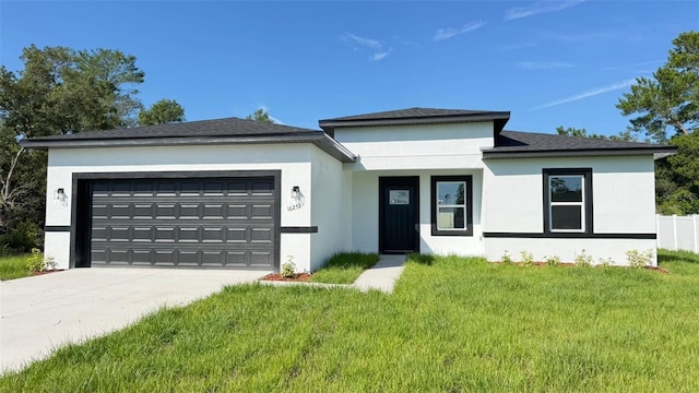 16252 SW 27th Terrace Rd, Ocala, FL 34473 - view of front of home featuring a garage, a front lawn, stucco siding, and concrete driveway