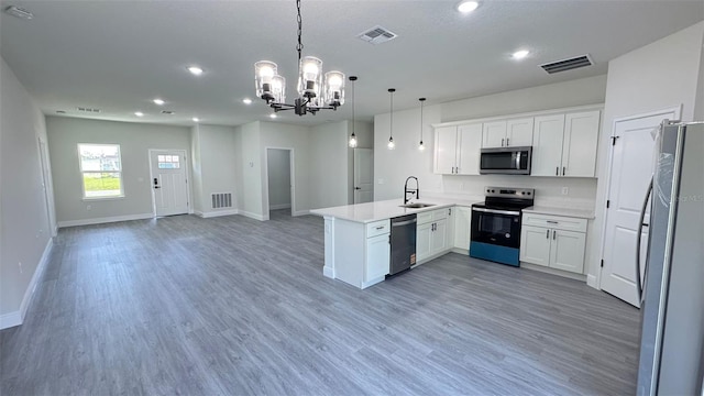 16252 SW 27th Terrace Rd, Ocala, FL 34473 - kitchen featuring appliances with stainless steel finishes, a peninsula, open floor plan, a chandelier, and recessed lighting
