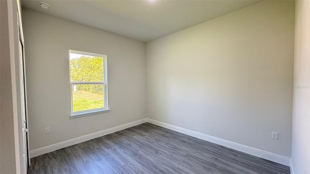 16252 SW 27th Terrace Rd, Ocala, FL 34473 - spare room featuring dark wood finished floors and a smoke detector