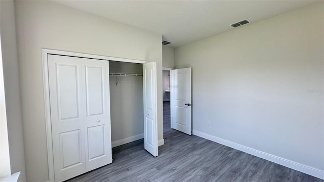 16252 SW 27th Terrace Rd, Ocala, FL 34473 - unfurnished bedroom with wood finished floors and a closet
