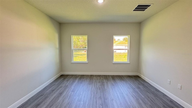 16252 SW 27th Terrace Rd, Ocala, FL 34473 - empty room with dark wood finished floors, a textured ceiling, and recessed lighting