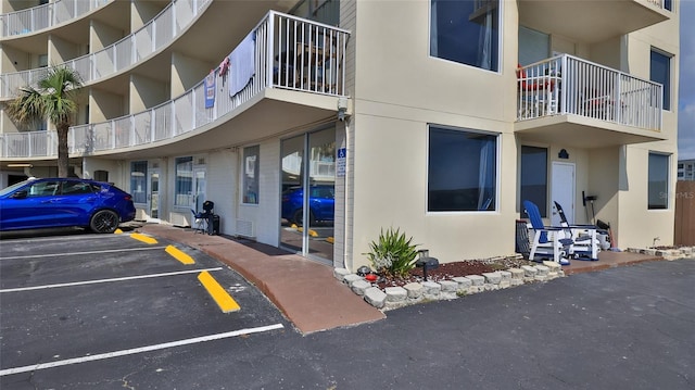 1233 N Atlantic Ave Unit 1020, Daytona Beach, FL 32118 - view of apartment building / complex featuring uncovered parking