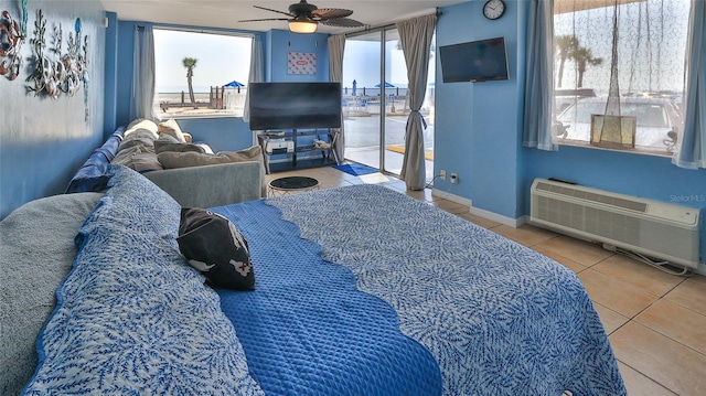 1233 N Atlantic Ave Unit 1020, Daytona Beach, FL 32118 - bedroom with tile patterned floors, access to outside, an AC wall unit, and a ceiling fan