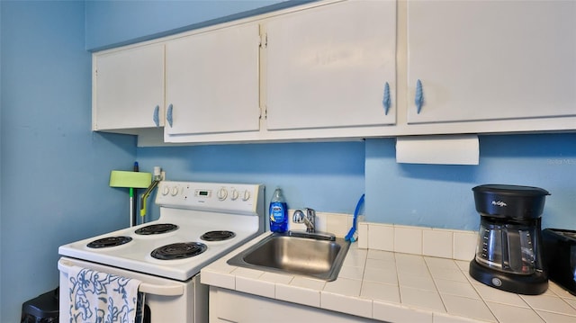 1233 N Atlantic Ave Unit 1020, Daytona Beach, FL 32118 - kitchen with white range with electric cooktop, tile countertops, and white cabinetry